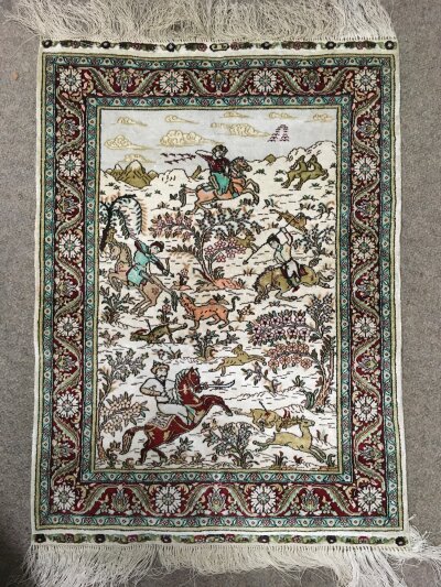 A small silk rug, approx 47cm x 76cm.