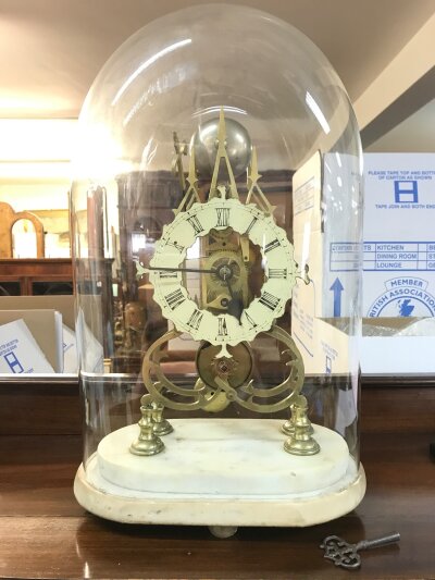 A Skeleton clock single fusee , with key. For restoration. Glass dome 48cm tall