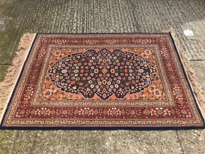 A hand knotted Persian rug. Dimensions 122x170cm