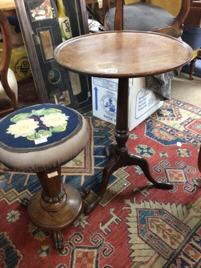 A George III mahogany wine table with a circular tip action top and and a Victorian Rosewood stool with an embroidered seat. (2)