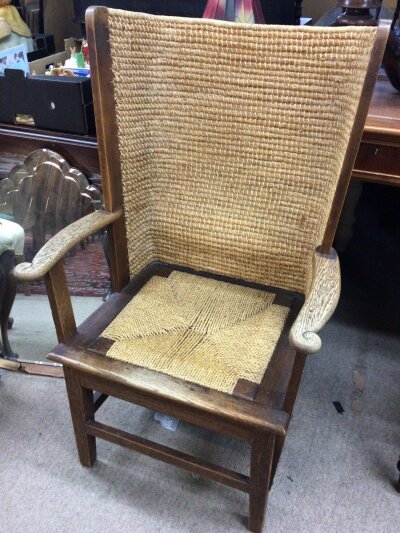 A Genuine Vernacular Regional Orkney chair with a traditional woven arched back and square seat with an oak frame scroll carved arm supports and square tapering legs. Height. 100cm