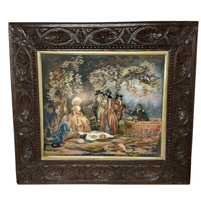 An unusual wool work tapestry / mixed media art work depicting an 18th Century Picnic scene of ladies and gentlemen in traditional dress for the time , watercolour background for Sky and Lake, with applied printed sections (Faces/Hands/food etc.) mounted within a carved oak frame. 71cm x 64cm