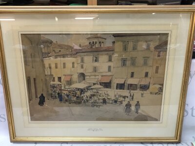 A framed watercolour, view of Market Square in Italy by Denys G Wells (1881-1973). Frame dimensions 76x58cm