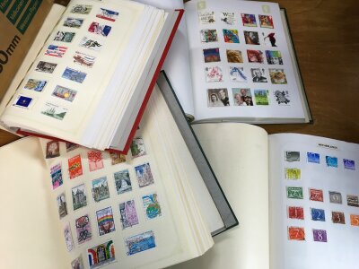 A box containing 4 stamp albums of various World stamps- NO RESERVE
