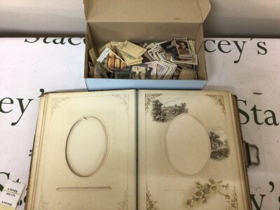 A collection of loose Vintage cigarette cards and OXO cards Kensitas and other cards and a late Victorian photograph album with a metal clip.