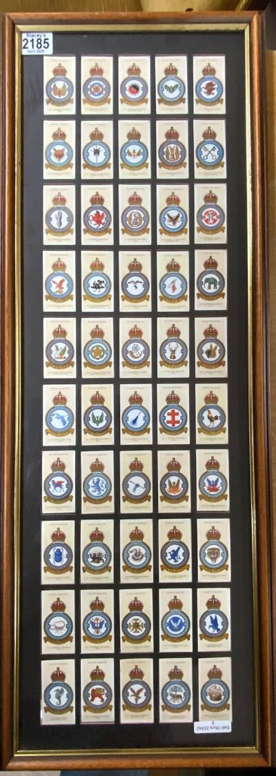 A framed collection of Players R.A.F badge cigarette cards.