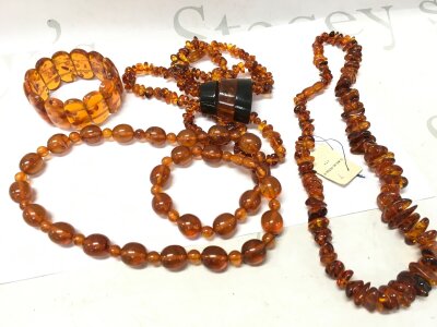 Lot of Four Baltic Amber items from Kaliningrad Amber Factory. 1 Bracelet, width 6-7cm (expandable), weight 40 grams. 1 Necklace, 67cm Long, weight 69 Grams. 1 Necklace with insert, 40cm for the neck, total necklace length 88cm, 56.6 gram 1 Necklace 100cm Long, 50 grams with Kaliningrad Amber Factory Sticker.