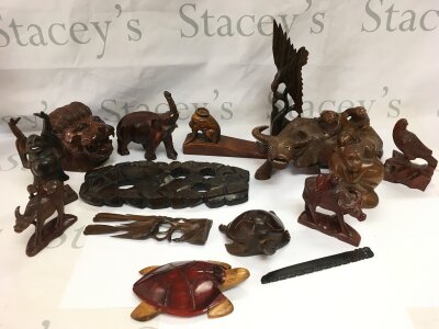 A collection of ornamental wood carvings including water buffalo, elephant etc.