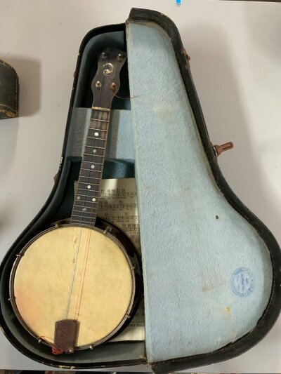 A vintage cased Whirlie banjo.- NO RESERVE