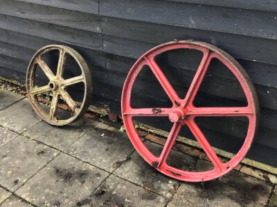 A Collection of Vintage Small holding farm equipment. Comprising sack barrows seed drills cast iron wheels.- NO RESERVE