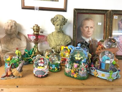 A collection of Disney snowglobes including Monsters Inc, The Lion King, Aladdin , villains etc No reserve