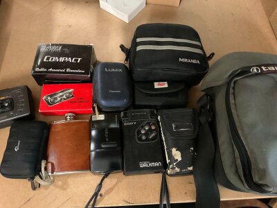 A small collection of cameras and binoculars.