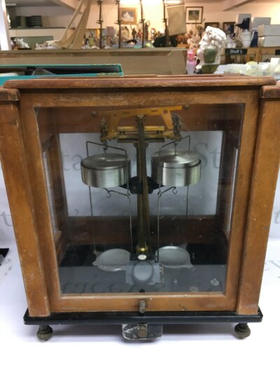 A cased pair of scientific balance scales.