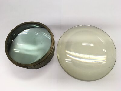 Two early magnifying lenses, one convex, one concave. Approx width 20cm and 15cm.