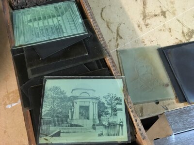 A collection of glass slides depicting portraits and various landmarks.