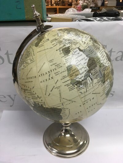 A modern globe on a chrome stand, approx total height 41cm.