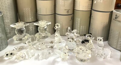 A  collection of small boxed Swarovski figurines.