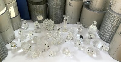 A  collection of small boxed Swarovski figurines.