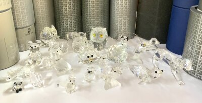 A  collection of small boxed Swarovski figurines.