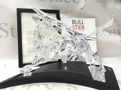 A cased Swarovski Crystal bull figure. Limited edition number 2587 of 10000. Designed by Adi Stocker. No damage or restoration