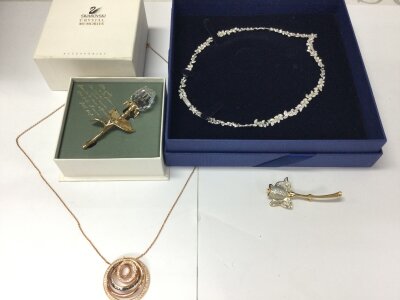 Four items of Swarovski crystal jewellery including two necklaces and two brooches