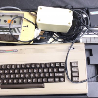 A Commodore 64 in Carry Case with 2 Cases of Software. 2 X Tape decks. And come with Original Box..(4)