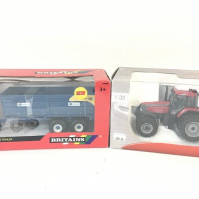 A Boxed Britains Kane 16 Tonne Grain Trailer #42701. And a Universal Hobbies MCCormick Tractor. Both 1:32 Scale.
