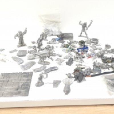 A box containing an assortment of Warhammer metal figures and accessories mainly unpainted.