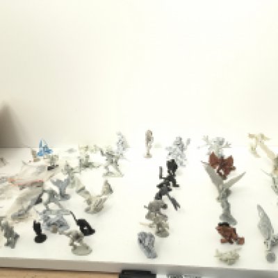 A collection in excess of 50 pieces of metal Warhammer figures and accessories. Mostly unpainted.