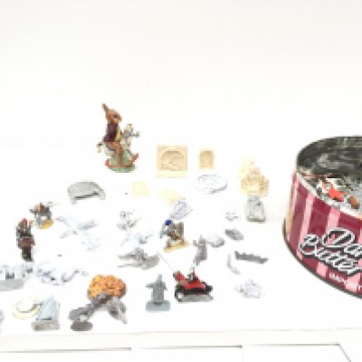 A tin containing numerous metal figures and other plastic accessories from a Warhammer collection together with a Doulton bunnykins figure.