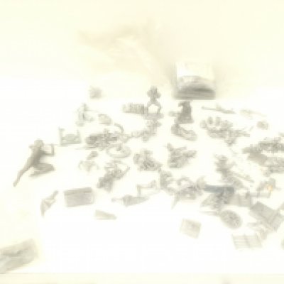 A box contains in excess of 50 unpainted metal figures and accessories from a Warhammer collection.