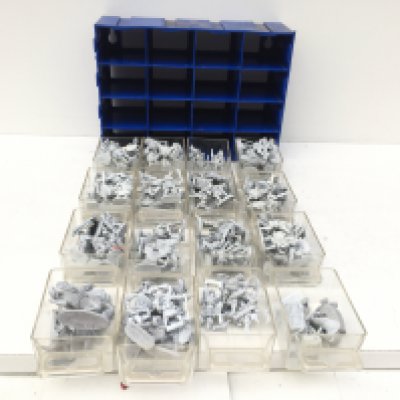 A 12 drawer storage unit containing metal model figures from a warhammer collection. Unpainted. Made by Grenadier and others.