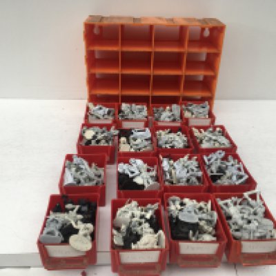 A twelve drawer storage unit filled with unpainted metal models from a warhammer collection. Made by Grenadier and others.