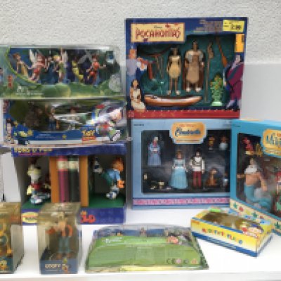 A collection of of 10 boxed Disney figures and sets. Including 2 original bobble heads ..Garfield bookends..and others.