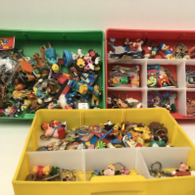 A collection of vintage and modern key rings including many Disney.