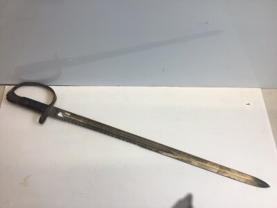 A Martini Henry 1879 Sawback edge bayonet the blade with military stamp marks no scabbard.