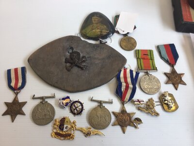 A Collection of II world war medals France German Stars badges Victory and Defence medals a Russian medal and other oddments.