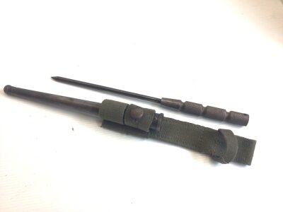 A rare D Day Allied Forces. label emergency issue modified stick fighting knife . With stamp marks and  1944. Engine turned grip steel scabbard. and green cloth belt hanger.