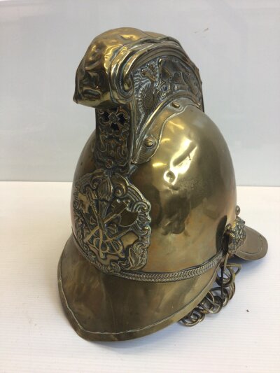 A  Victorian brass Fireman’s helmet.