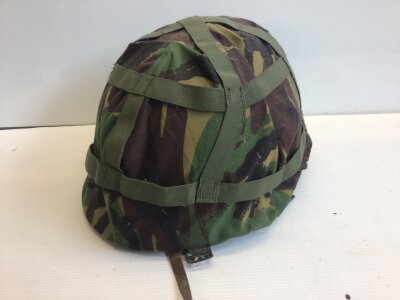 An American Combat helmet with camouflage cover. Vietnam era.