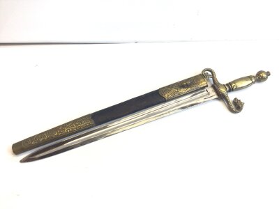An unusual early 20th century short sword with brass grip the cross guard with a scrolling lions head and brass mounted scabbard.