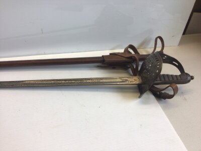An Edward VII officers  cavalry sword the steel blade and guard with Royal Cypher.  The blade edge stamped number 17409  with a leather scabbard and hanging leathers.
