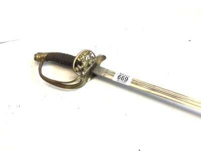 A German Imperial Infantry Officers sword with a hinged guard with imperial eagle the steel blade with makers marks no scabbed.