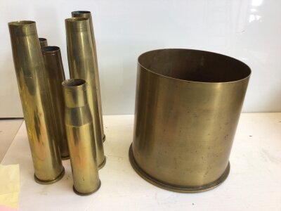 A large German imperial I world war shell case large Mortar shell of unusual large size diameter 22cm marks to the base see image and date 1917 and six other 40mm and similar shell cases. (7)