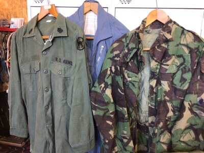 A Vietnam US army field shirt black cats 81 Infantry a 1970 blue pilots light weight flying suite and two other military garments (4)