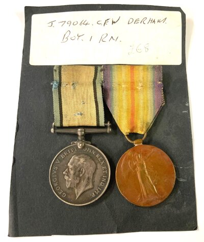 A pair of WW1 medals awarded to J.79064, C.F.W Dereham BOY. 1 RN