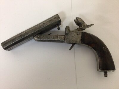 A 19th century early example of a Continental pin fire double barrel pistol with a walnut grip with double retractable triggers.