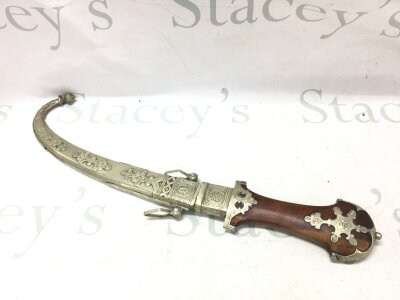 A large 19th century Arabian Jambiya with possibly white metal mounts. 44cm wide. Blade 24cm wide