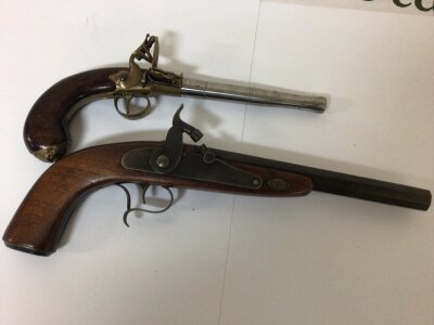 Two good quality Replica antique pistols a flintlock with steel canon barrel and a percussion pistol non firing ornaments (2)