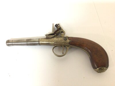 A Replica flintlock pocket pistol with a detachable steel canon barrel brass action and mahogany grip. Non Firing ornament. 20cm long.